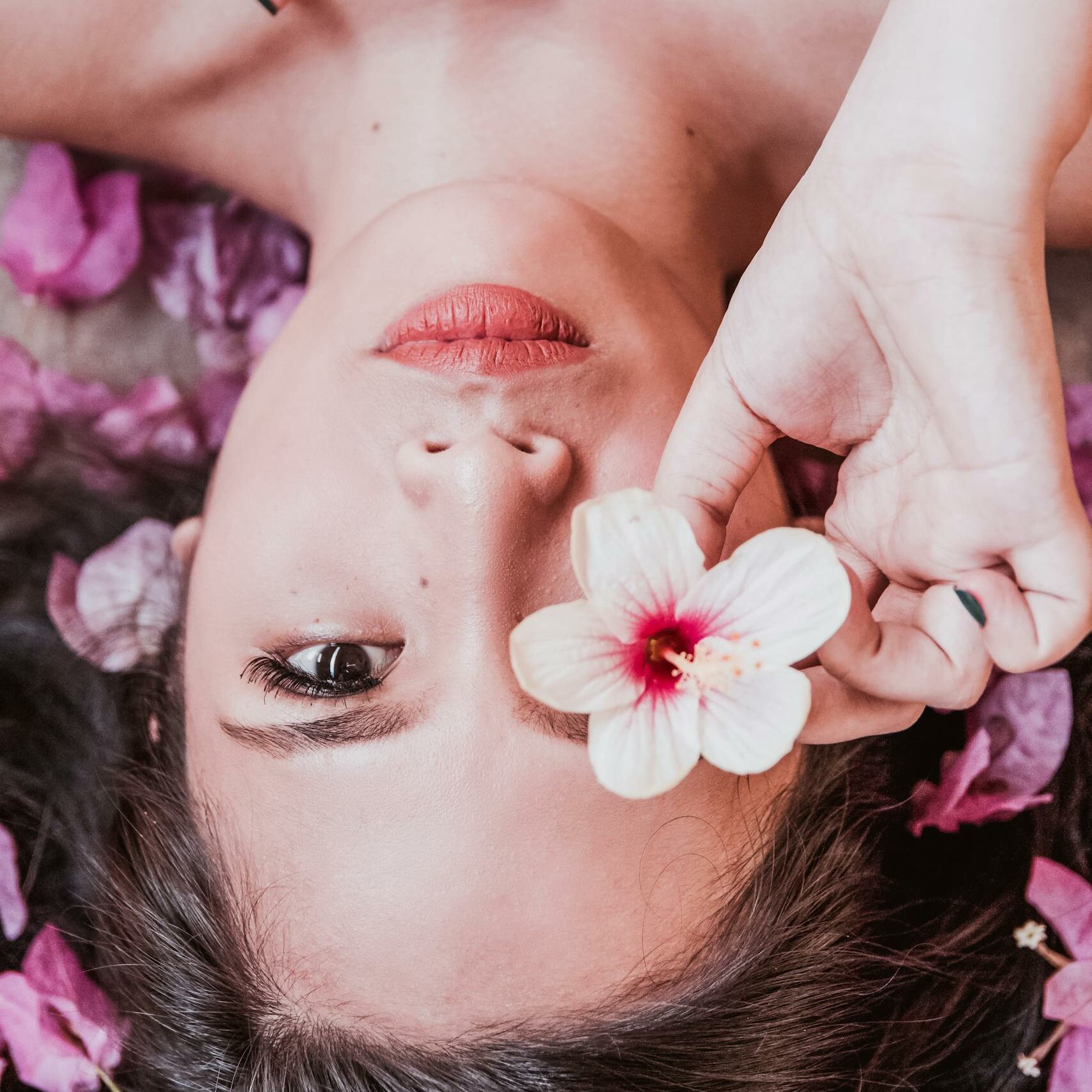 Photo of Woman Holding Pink Flower